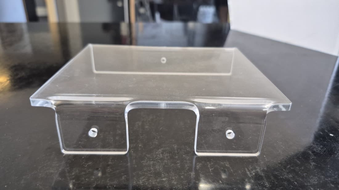 Clear acrylic switchboard cover with mounting holes and a cut-out, custom fabricated for electrical equipment
