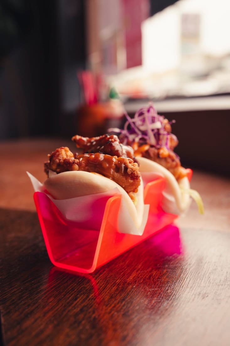 Bao buns served in a custom pink acrylic food presentation holder
