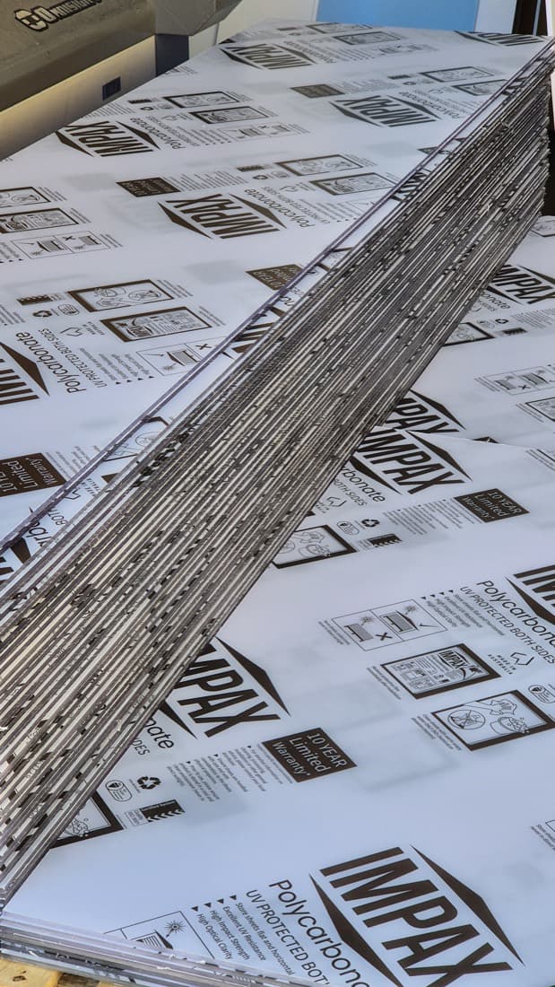 Stacked UV-protected polycarbonate sheets ready for fabrication and supply