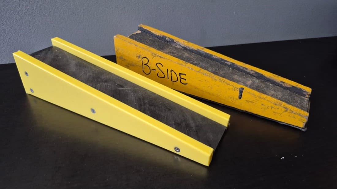Yellow polyurethane-coated slopeboards showing the new fabricated part beside the worn original