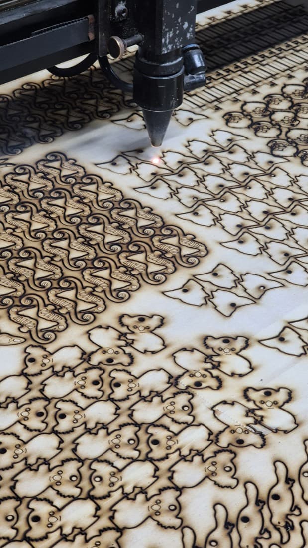 CNC laser engraving a 'Derwent Distillery Tasmania' branded plywood panel with QR code